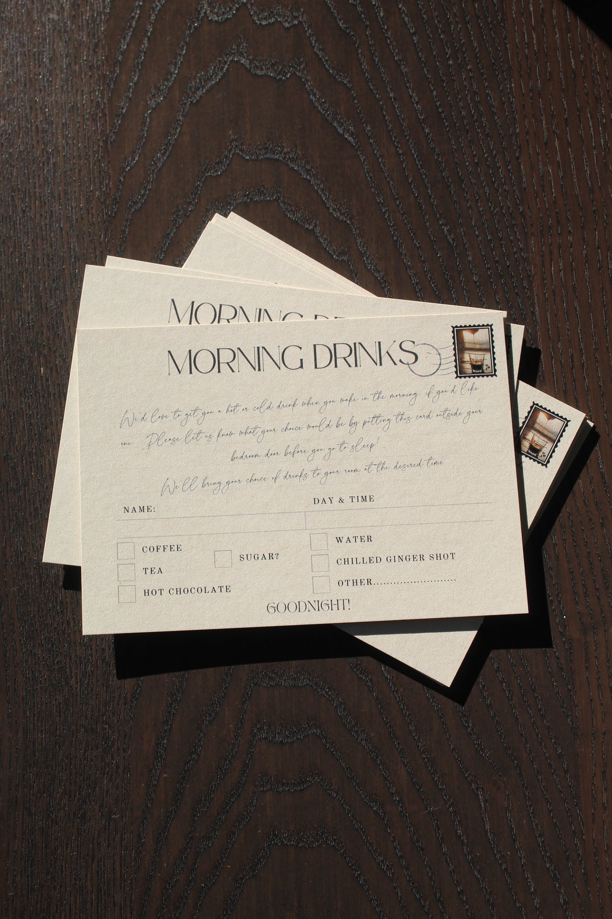 Stack of formal invitation cards on a wooden surface