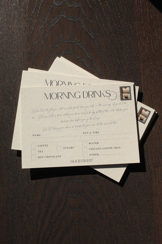 Stack of formal invitation cards on a wooden surface