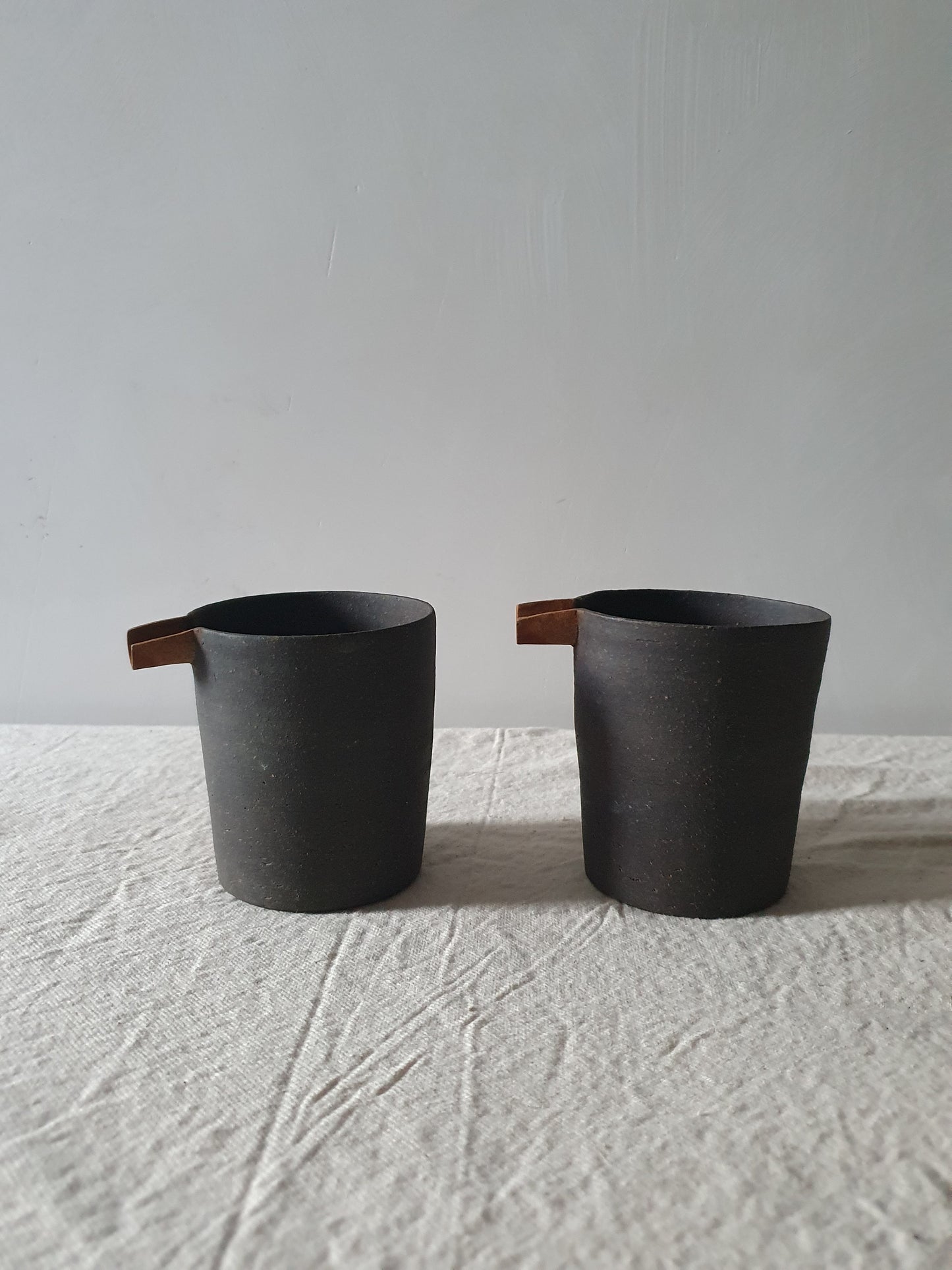 Blackened Tan Pottery Jug