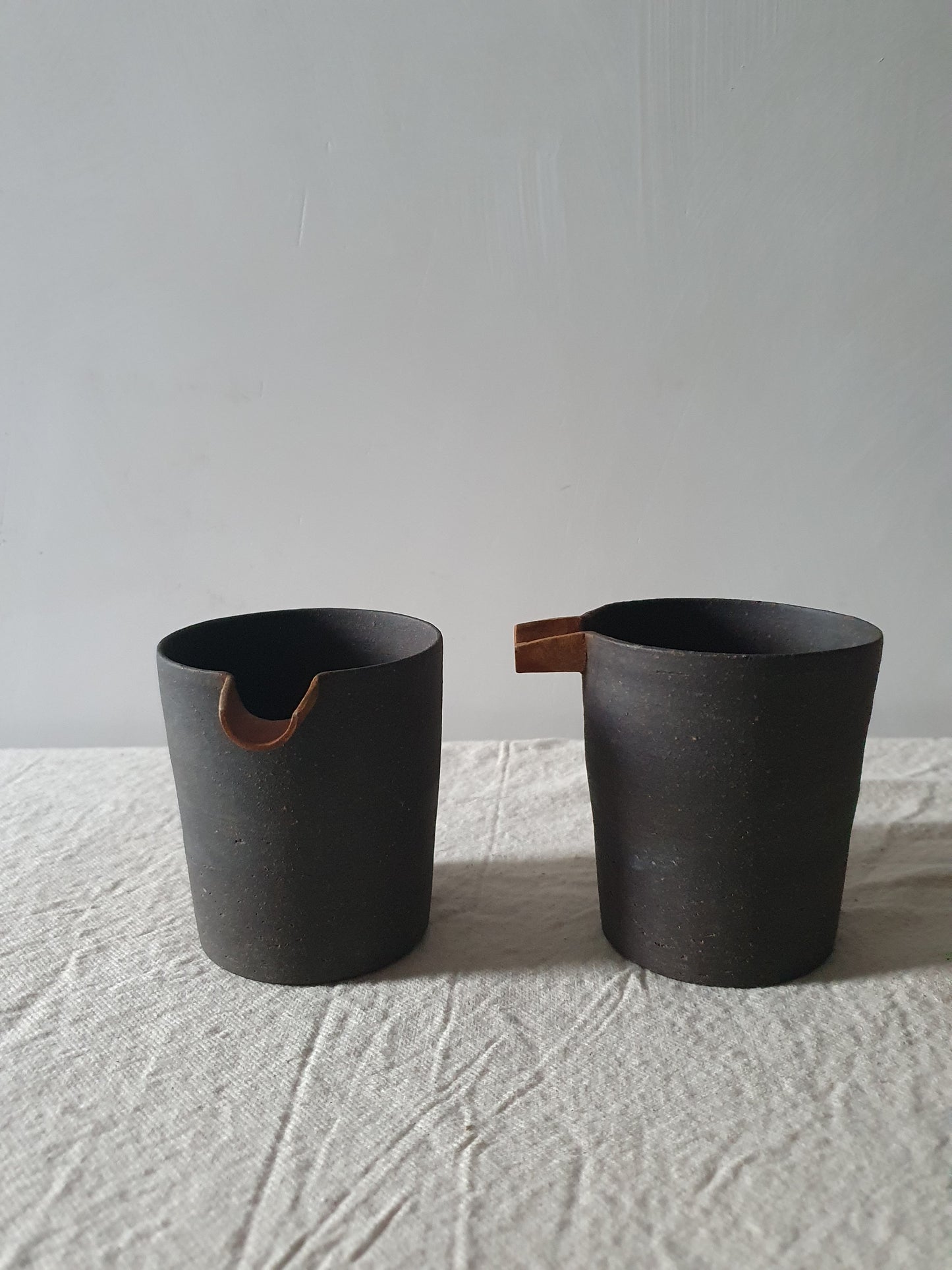 Blackened Tan Pottery Jug