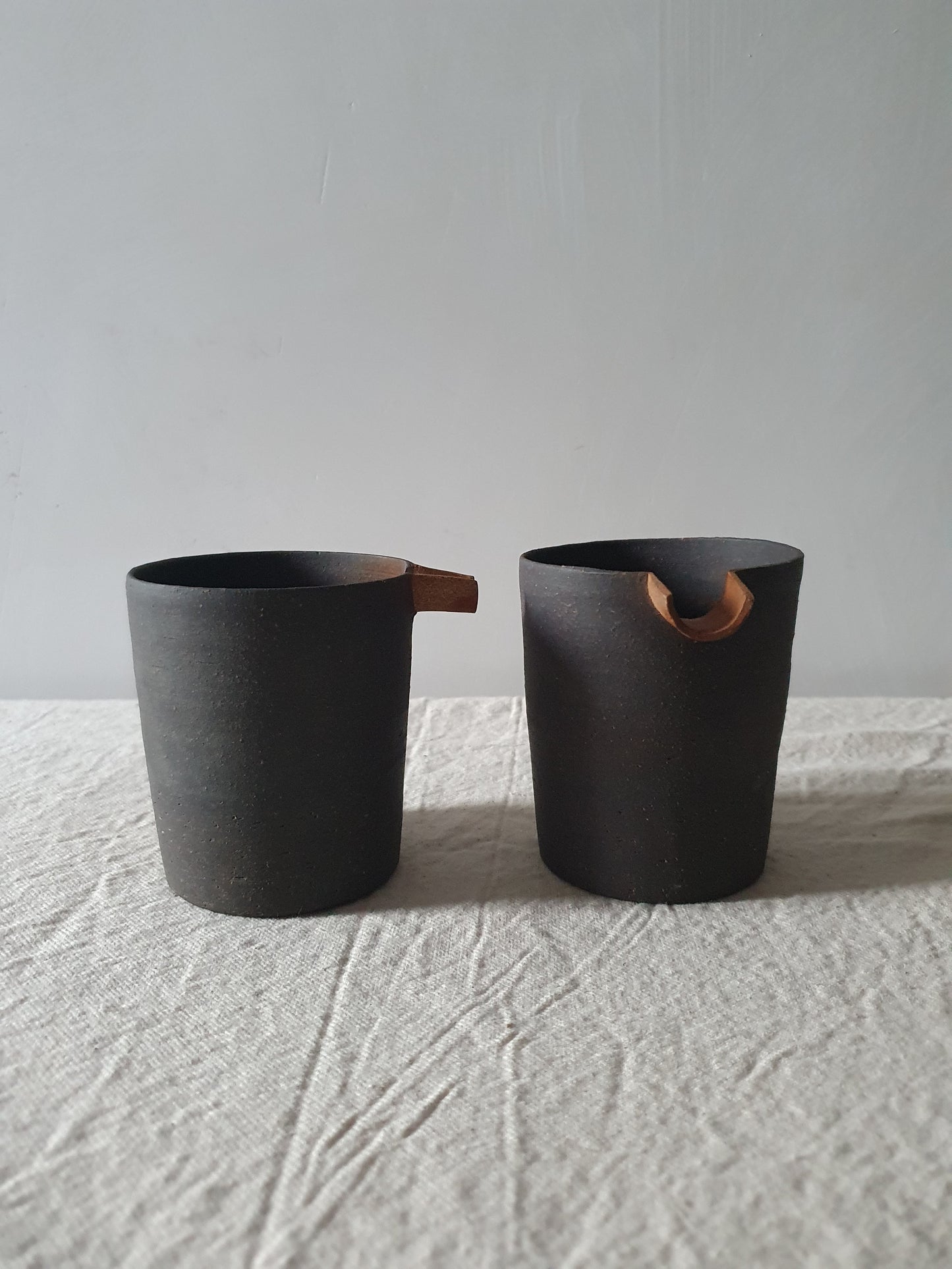 Blackened Tan Pottery Jug