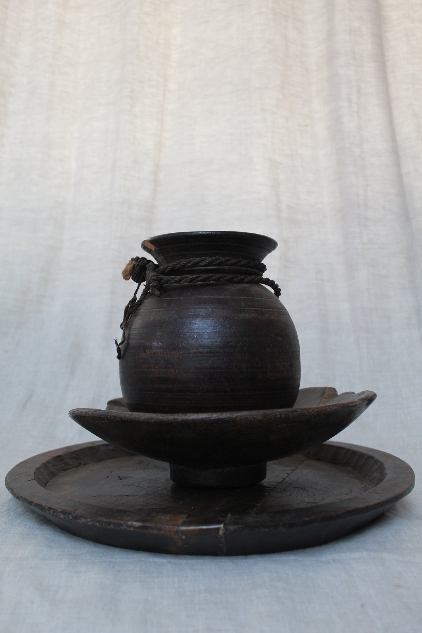 Black wood object on a light gray background