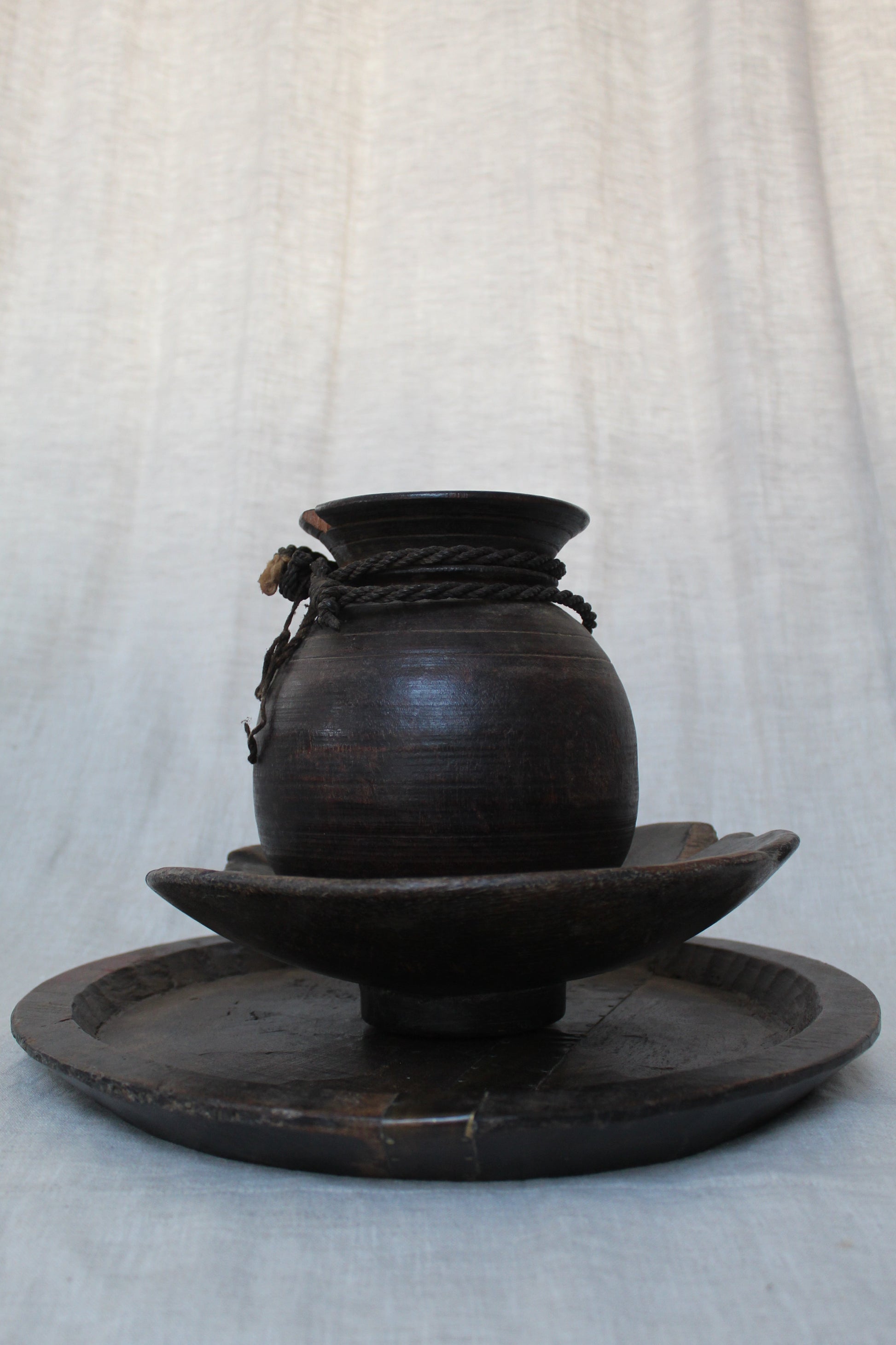 Black wood object on a light gray background
