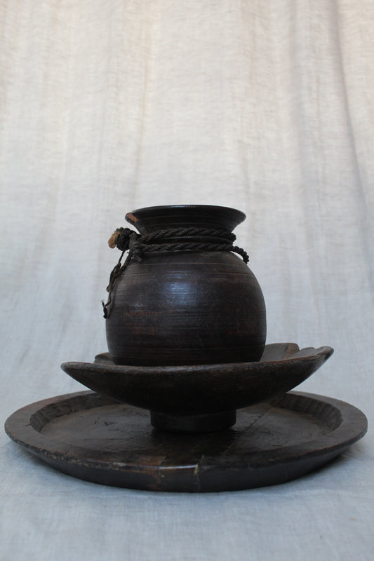 Black wood object on a light gray background