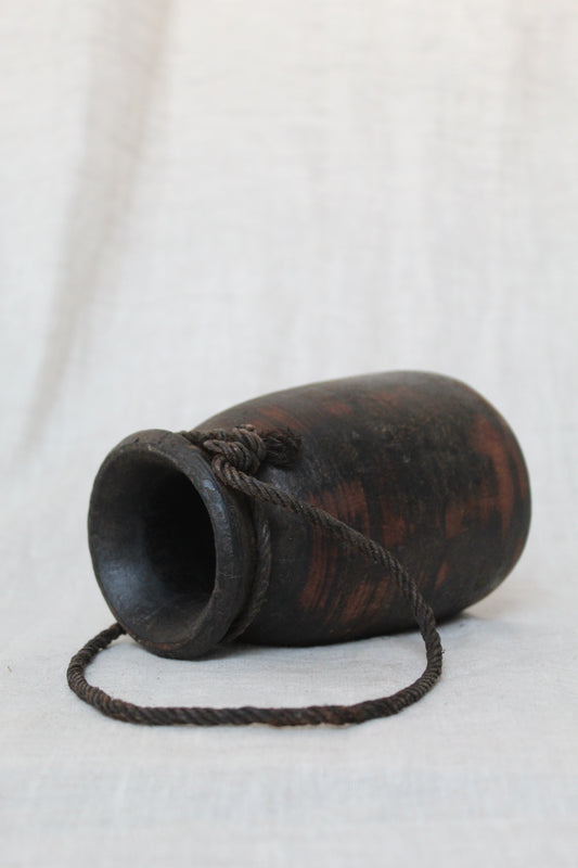 Black urn with red accents on a white background