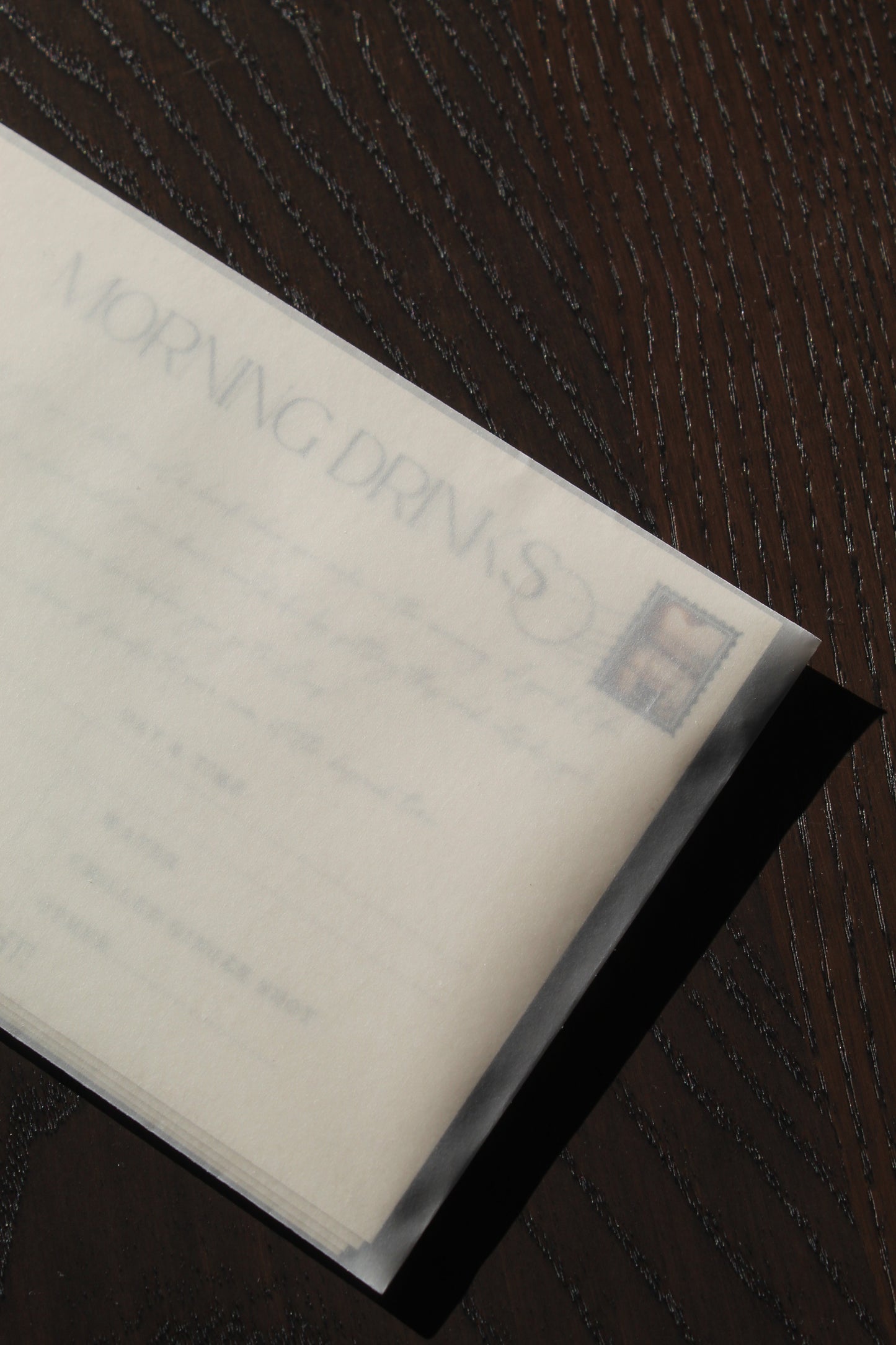 Cards in velum envelope on dark wood background