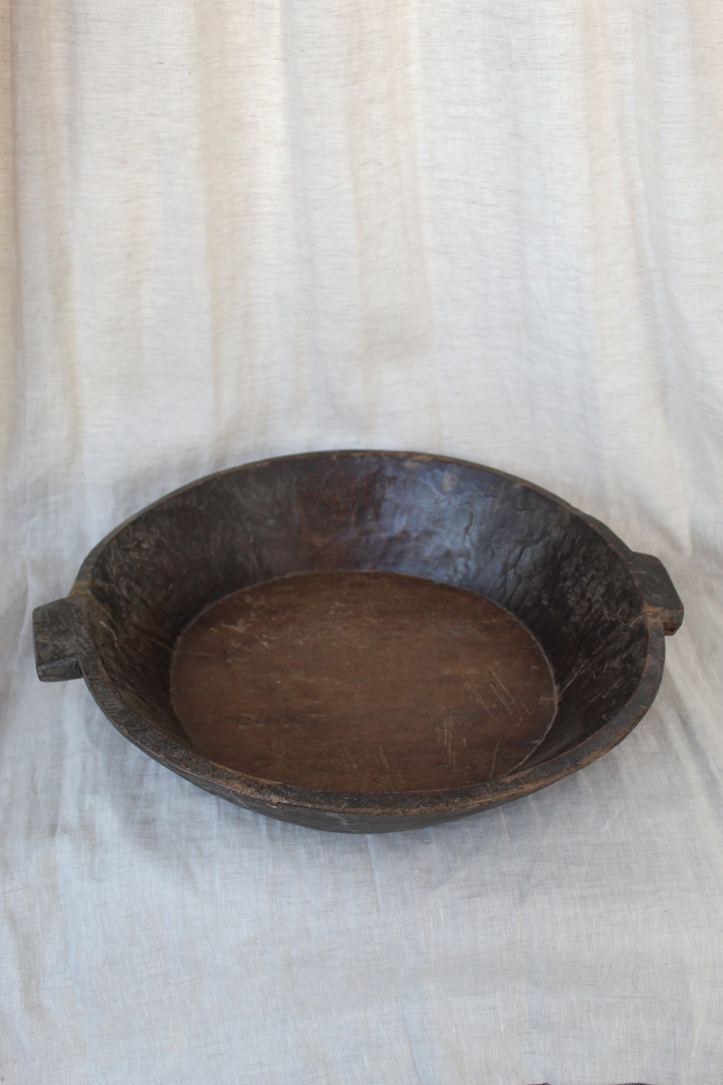 Wooden bowl on a textured white background