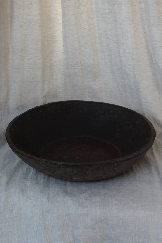 Dark brown oval object on a striped fabric background