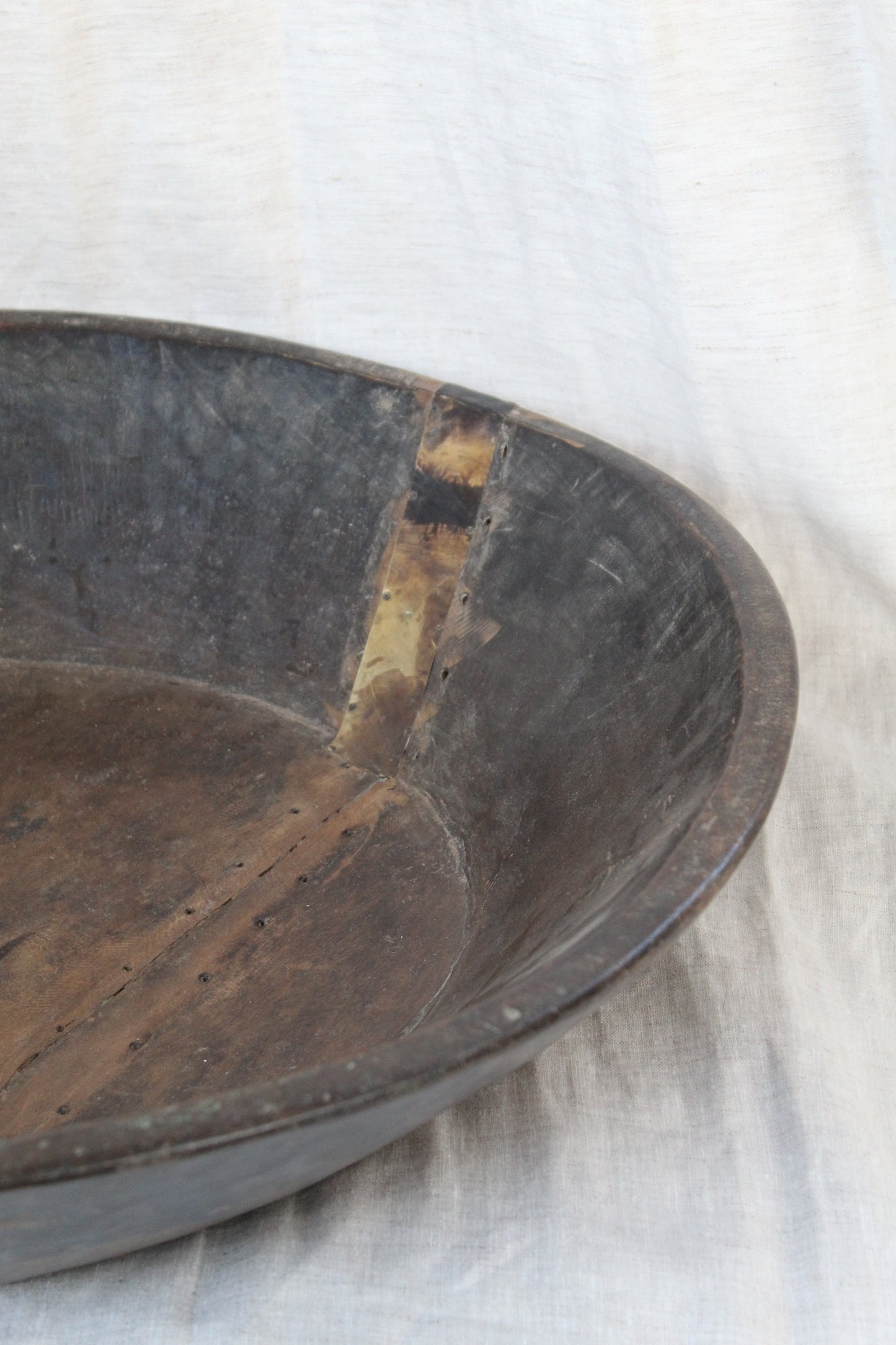 Close-up of a wooden bowl with visible wear and tear.