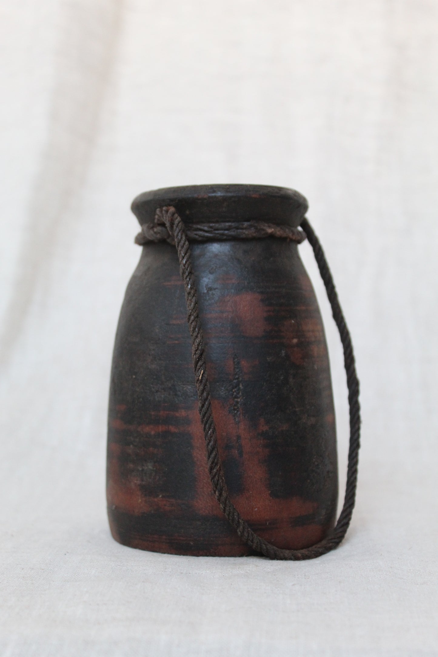 Black Wooden Urn with red accents on a white background