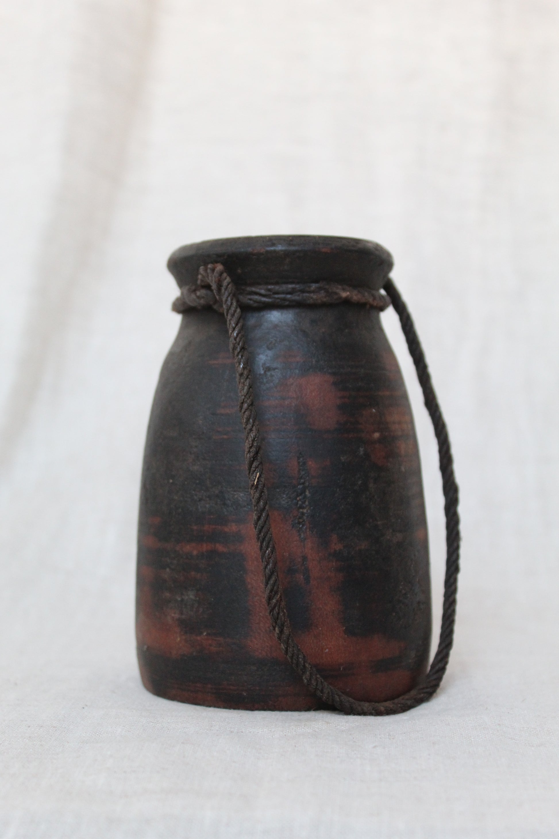 Black Wooden Urn with red accents on a white background
