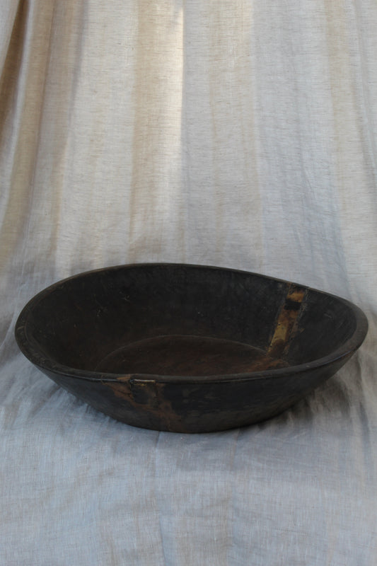 Black circular object on a textured white background