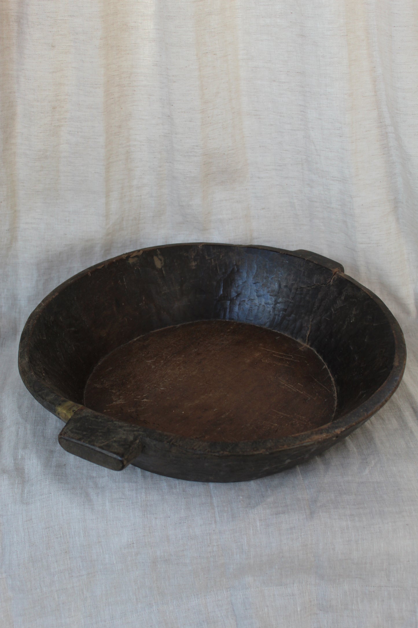 Wooden bowl on a light fabric background